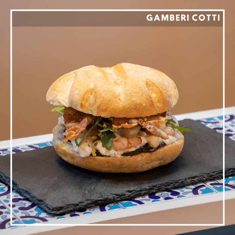 Gamberi leggermente bolliti, zucchine alla scapece, bacon, granella di pistacchio mozzarella di bufala, rucola e maionese al gambero